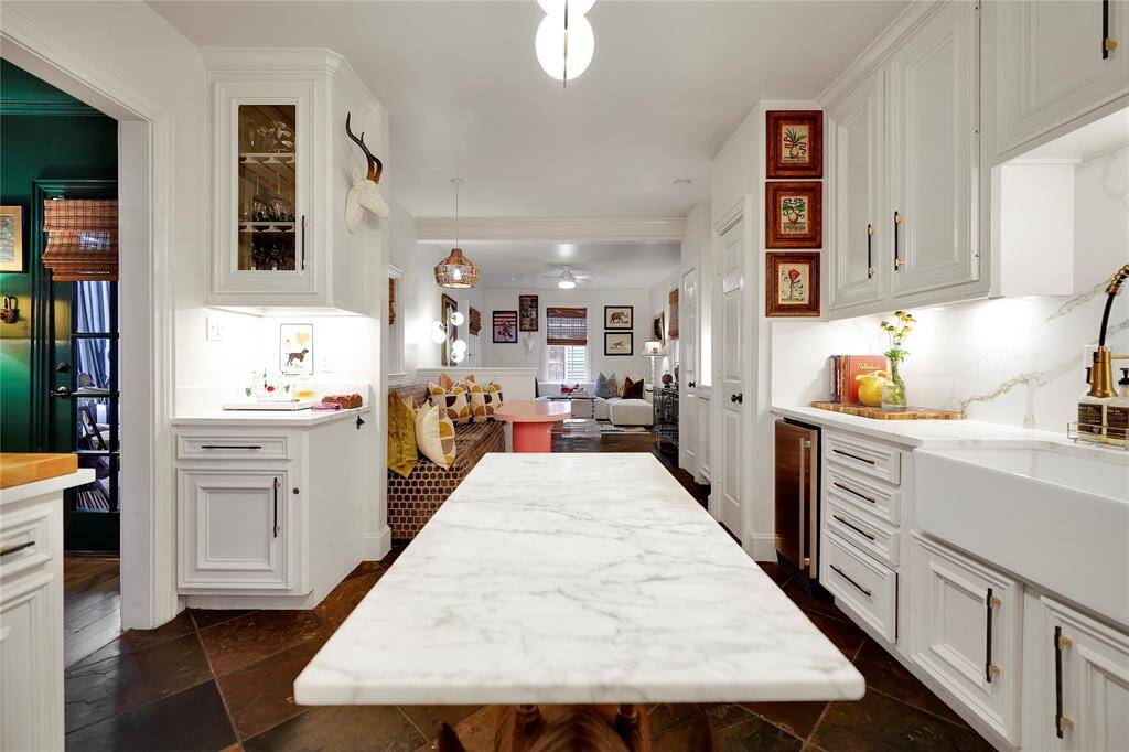 Kitchen upgrades include new quartzite countertops, backsplash, marble island, new farm sink,ice maker,and refinished cabinetry