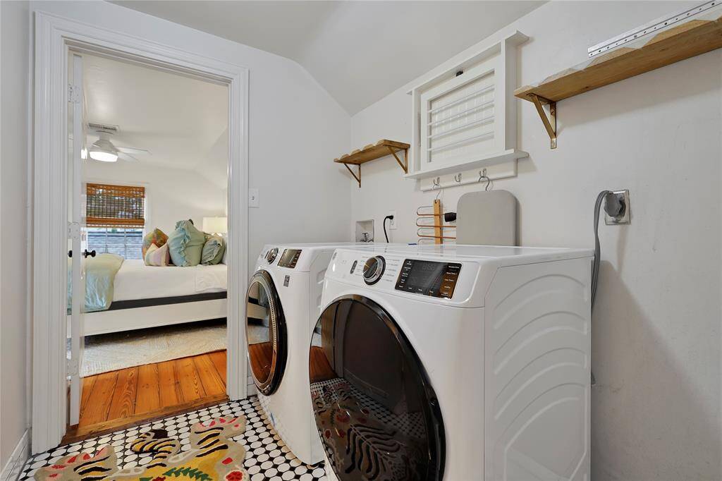 Laundry room is conveniently located by the two secondary bedrooms.