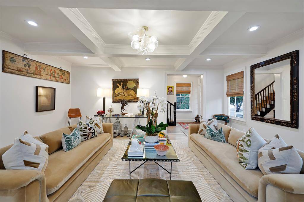 The formal living room boasts elegant coffered ceilings with a bohemian flair