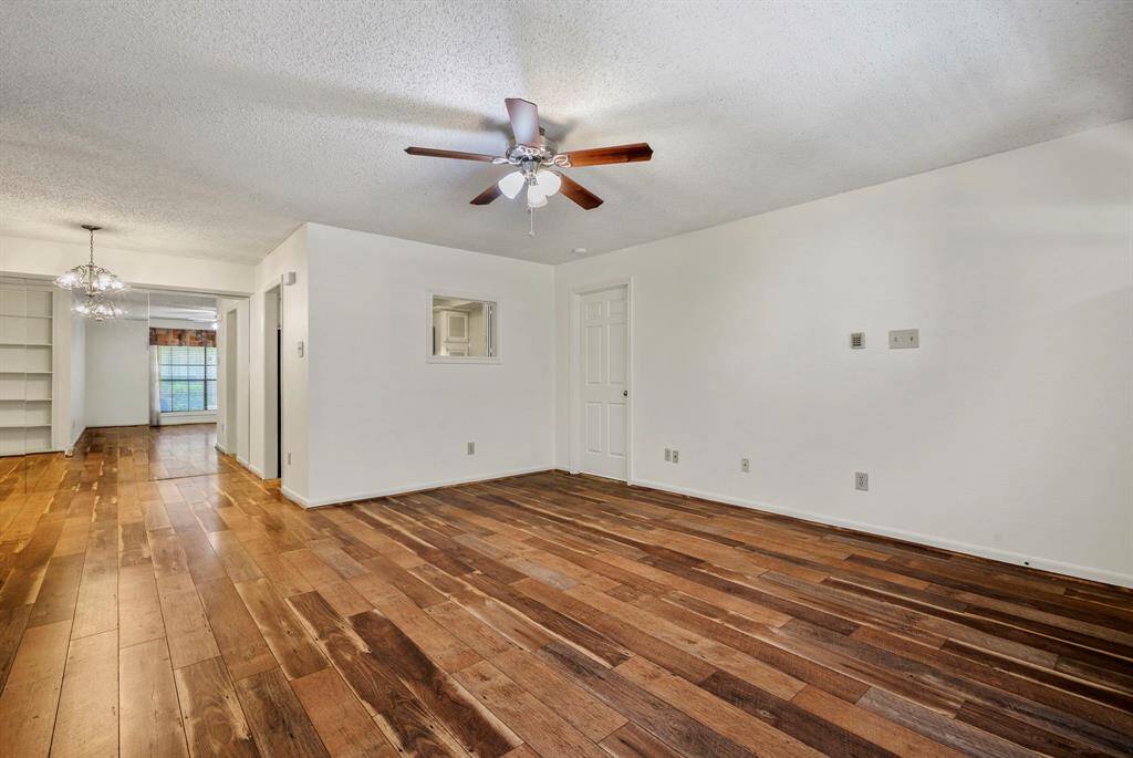 15x14 Living Room - Photo shows view standing in the living room while looking back at the dining room on the left and door on the right which opens to the primary bedroom.