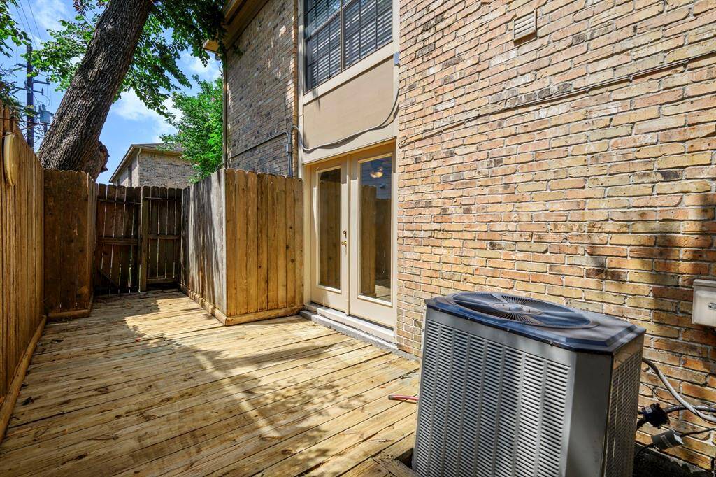 Private patio with wood deck outside of the primary bedroom.