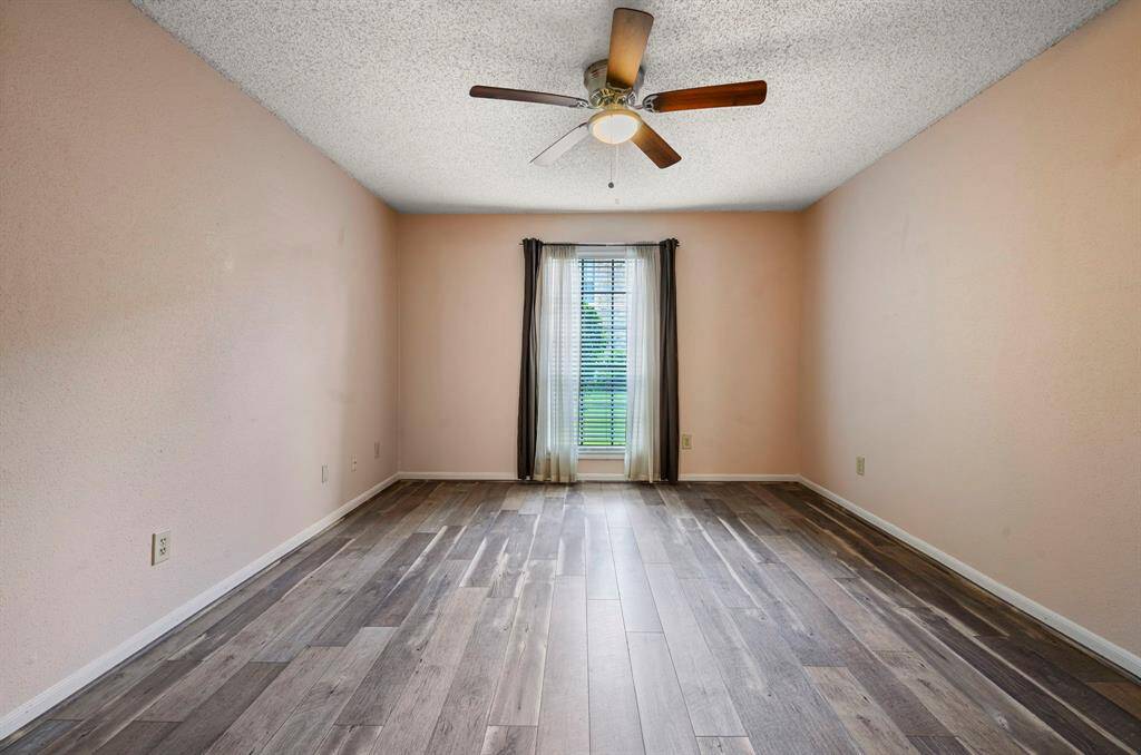 13x12 Bedroom - Stay cool with ceiling fan and enjoy a nice view of the landscaping in front of the home.