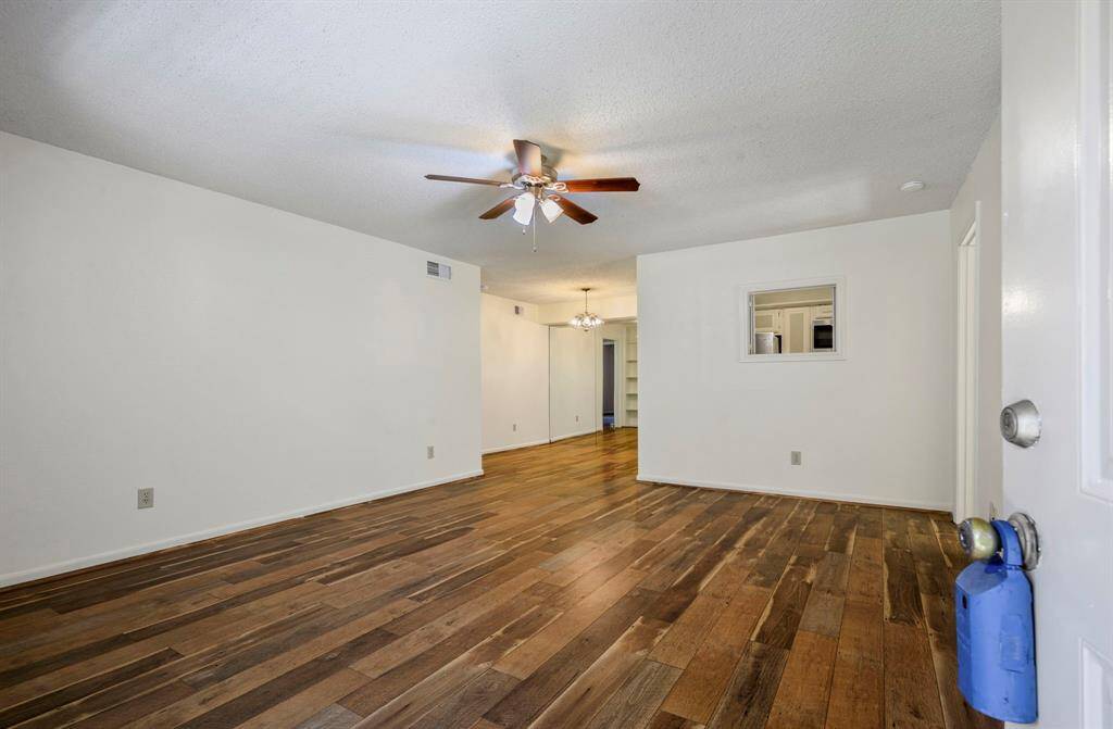 15x14 Living Room - Walk in through the front door and see that the open area has a ceiling fan and pass through to the kitchen. Dining area is shown in the background.