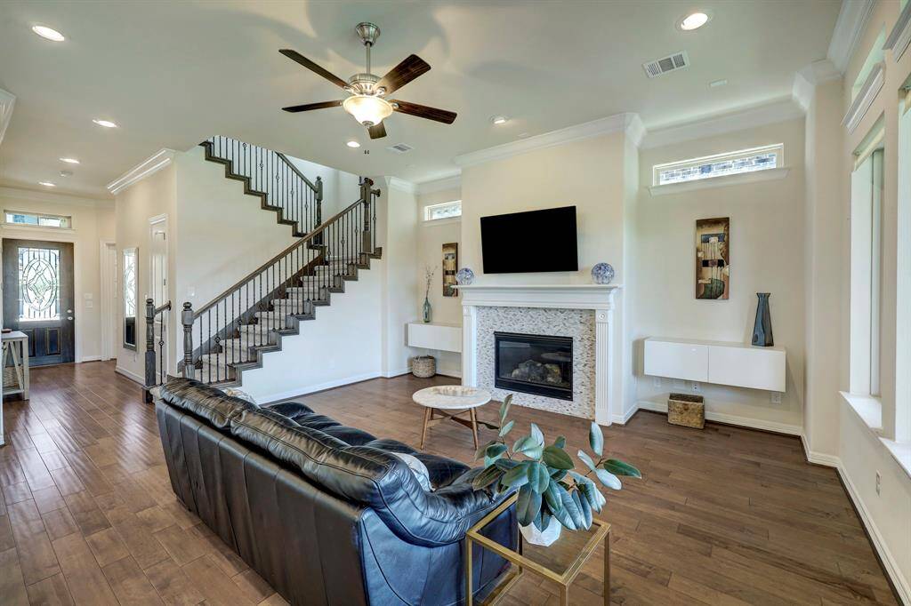 Gorgeous view of the family room from the formal dining. Family Room offers a gas log fireplace a neutral mantel and TV.