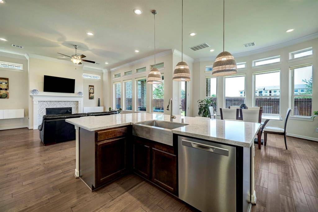Fabulous expansive kitchen island with deep Farmhouse Sink that makes a statement to the gorgeous kitchen island. Wonderful breathtaking views of the serene backyard and covered veranda while cooking. Covered veranda is accessed by a glass door just steps away from Kitchen.
