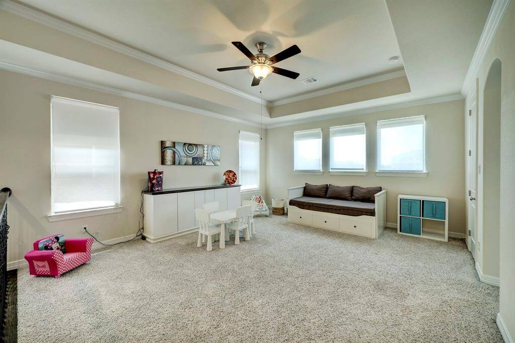 Situated on the second floor, thus game room can also double as an upstairs common room. It boasts a neutral color, high-recessed ceilings, and window panels that graces the space with an ambient feel.