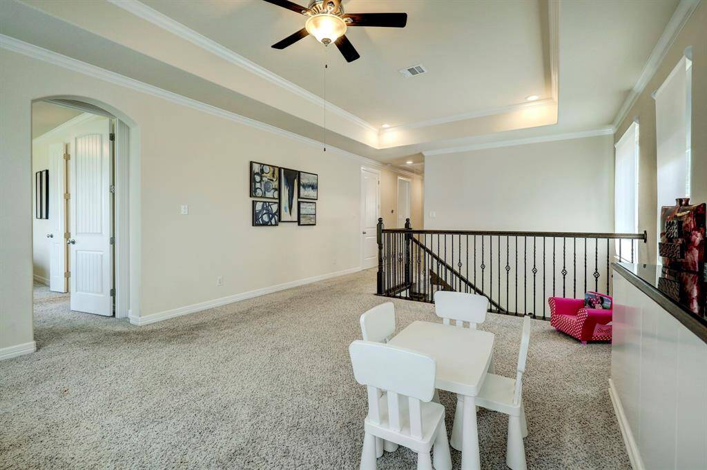 View of the second-floor landing and entrance to the Primary Bedroom from the game room/common area.