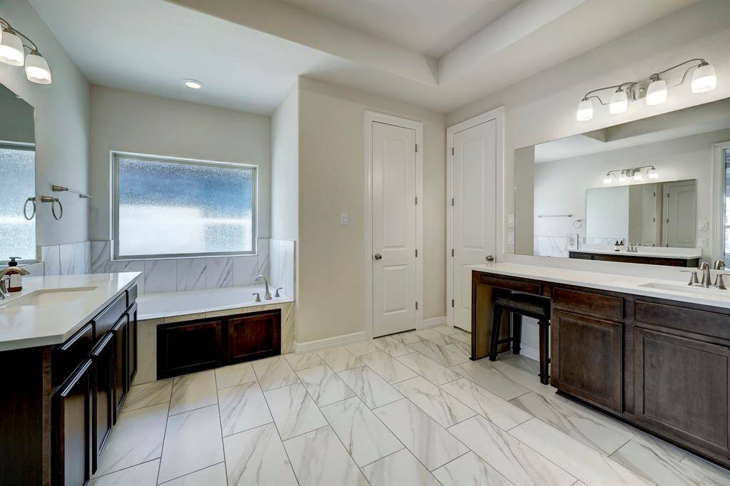 A glimpse of the primary bath seen from the enclosed shower space.