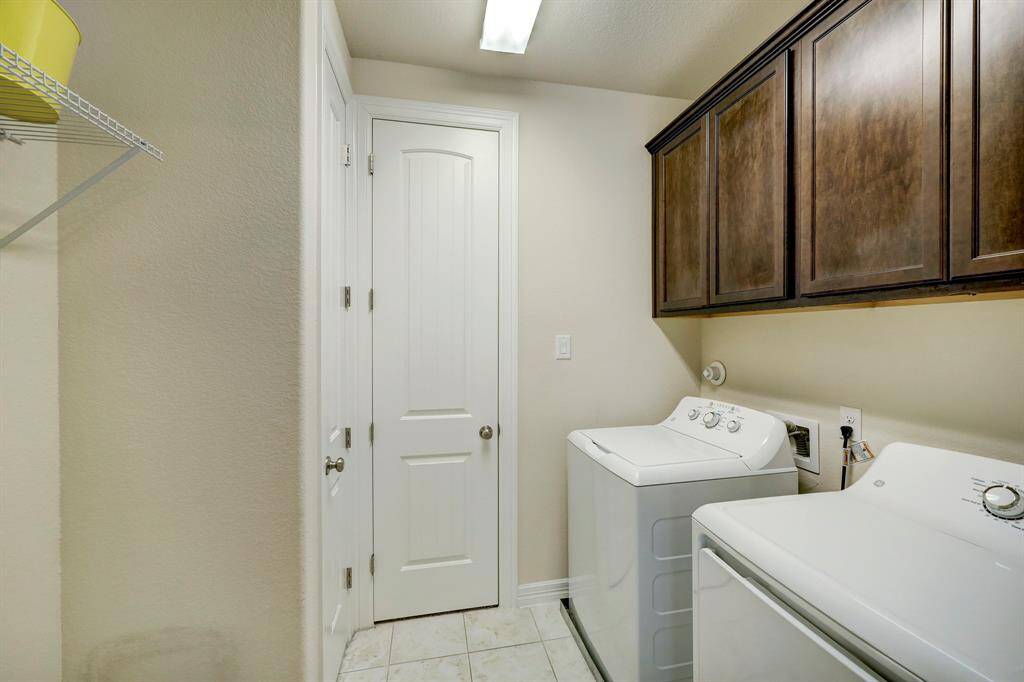 The utility room on the second level offers convenience, with direct access from both the primary bedroom and the second-floor hallway.