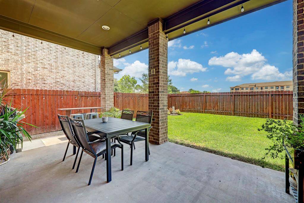 The covered veranda can be conveniently accessed from the formal dining area, offering a delightful vantage point to admire the lush green backyard and soak in the beauty of the blue skies.
