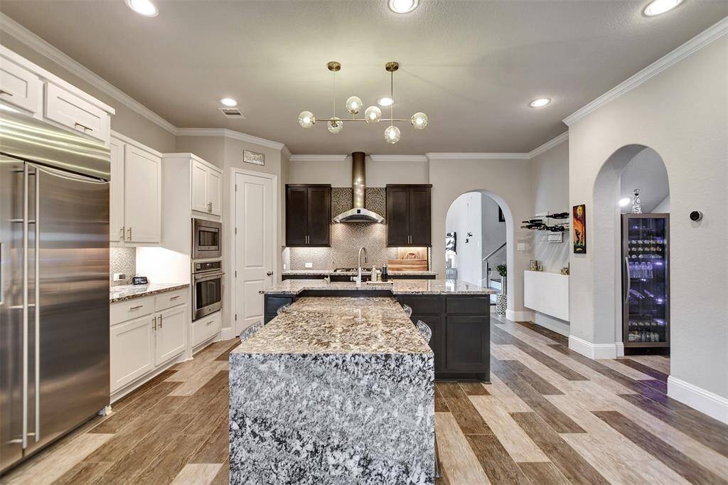 Kitchen upgrades include: counter depth refrigerator, high end wood floors, modern light fixtures, undermount lighting, upscale appliances, and more.