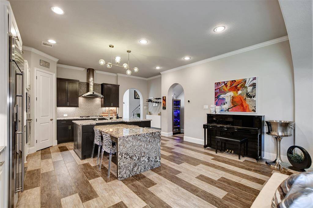 This modern kitchen includes built-in appliances and ample storage, offering a clean and elegant space perfect for cooking and entertaining.