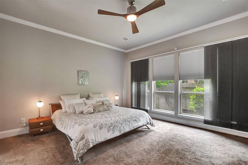 The primary room is spacious, modern, with neutral colors and lots of natural light.
