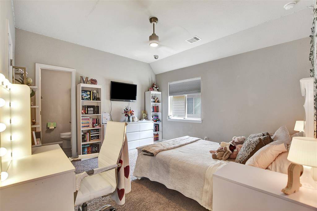 Spacious Third bedroom with abundant natural light from large windows. The neutral walls and carpet create a warm and relaxing atmosphere. This bedroom has its own private bath.