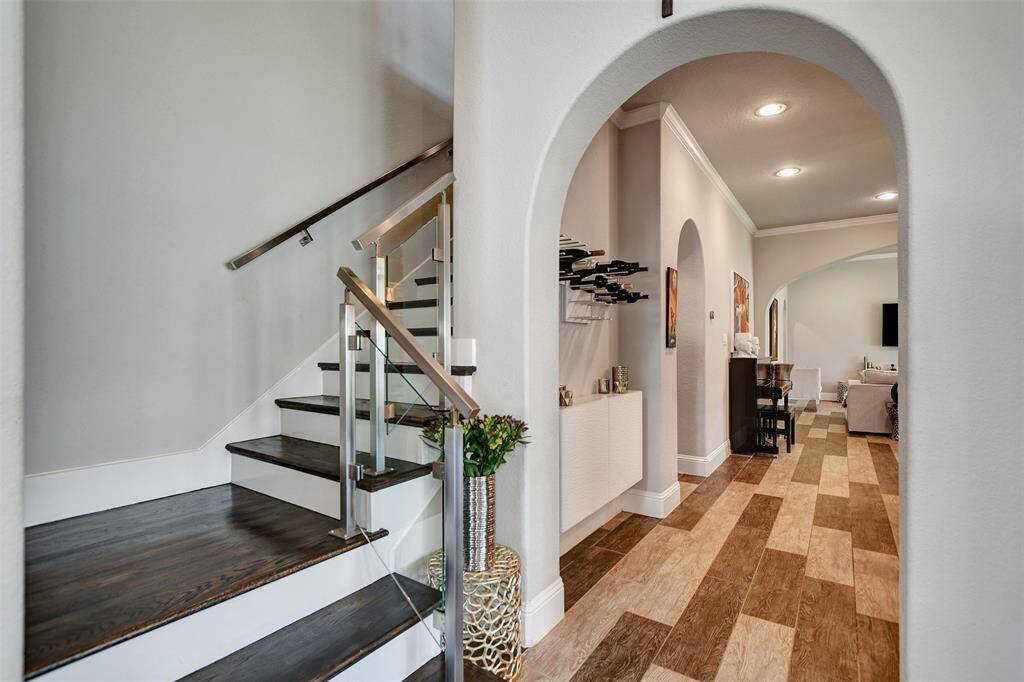 Elegant stairs to the left welcome you to the upstairs rooms, media and gameroom.
