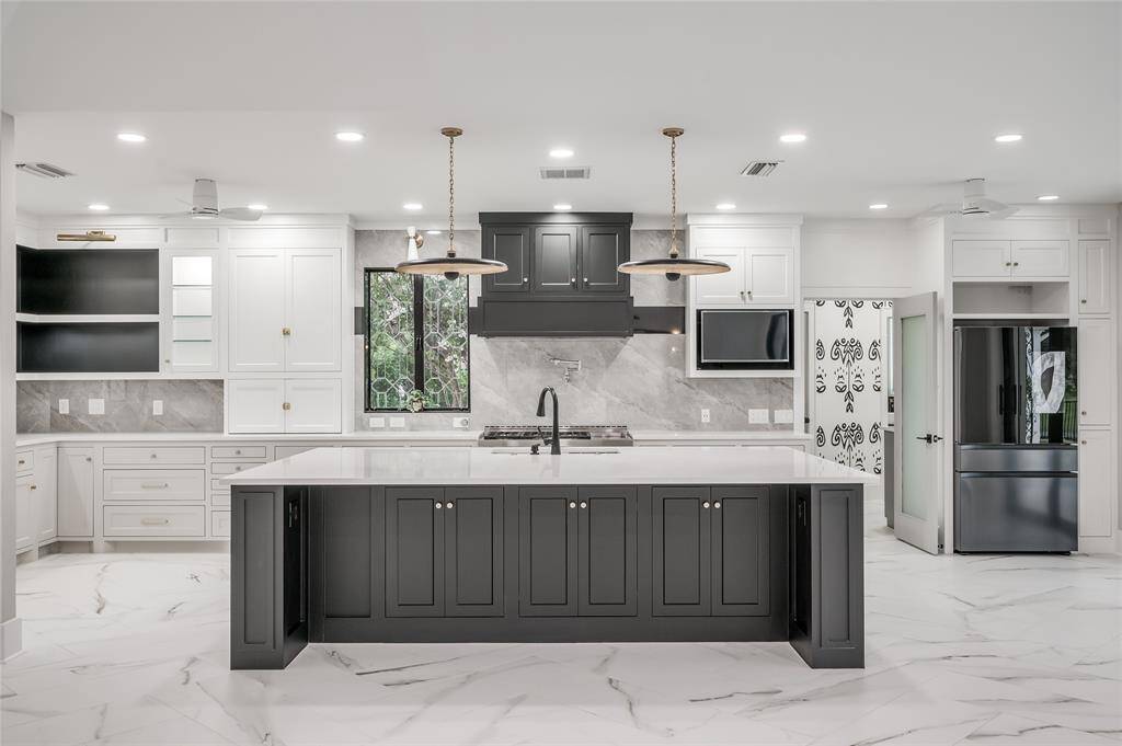 The expansive kitchen island provides ample space for culinary endeavors and is a central hub for social gatherings.
