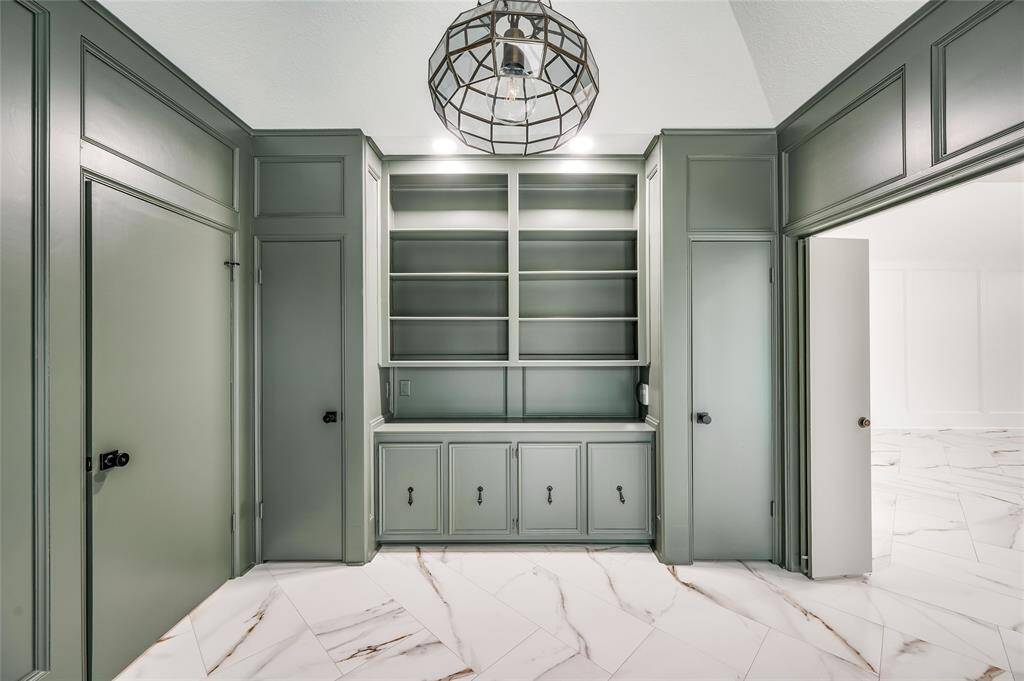 Built-in bookshelves and cabinet storage is flanked by two closets. Folding doors provide privacy. This room could be used as a 4th bedroom.