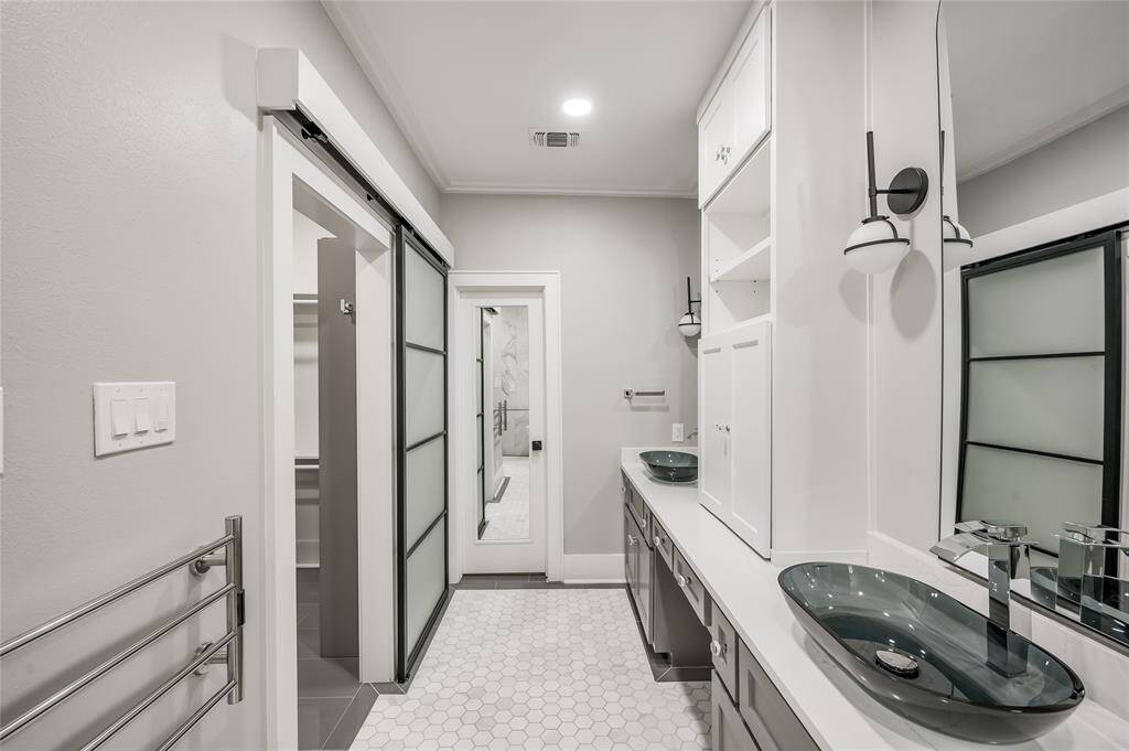Sliding glass door opens to walk-in closet. Hex tile flooring.