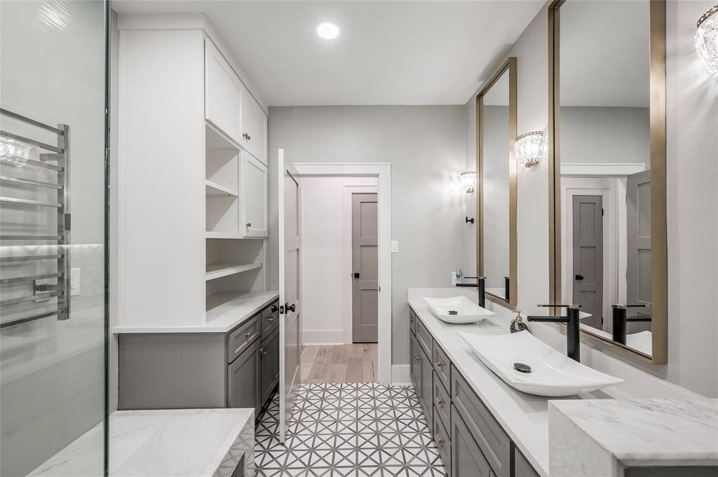 Spacious secondary bathroom with two entrances and loads of storage space.