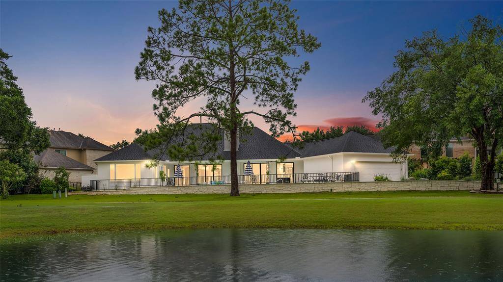 Large windows and glass doors along entire back of house.