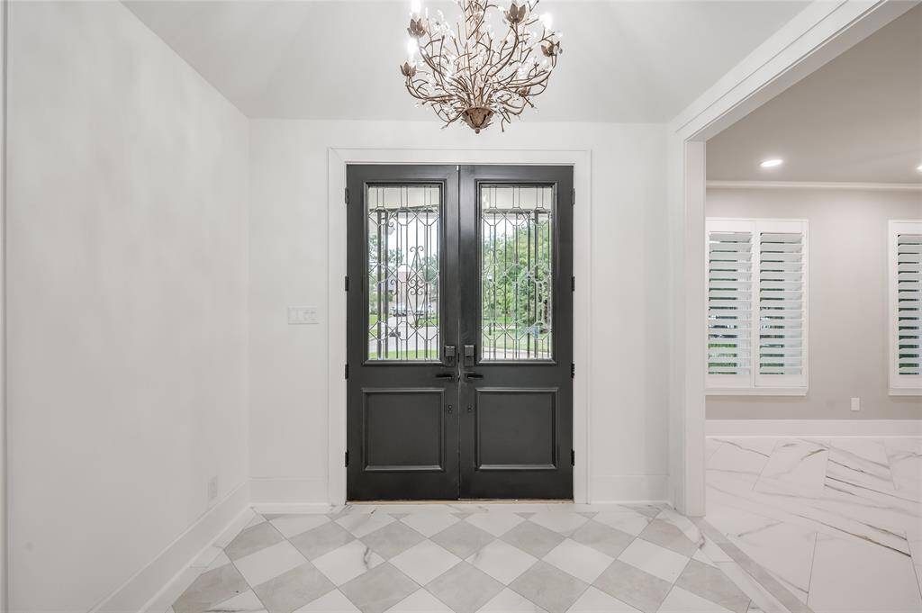 Elegance abounds the moment you step inside. Marble tile flooring, leaded glass doors, and whimsical chandelier greet you and your guests.