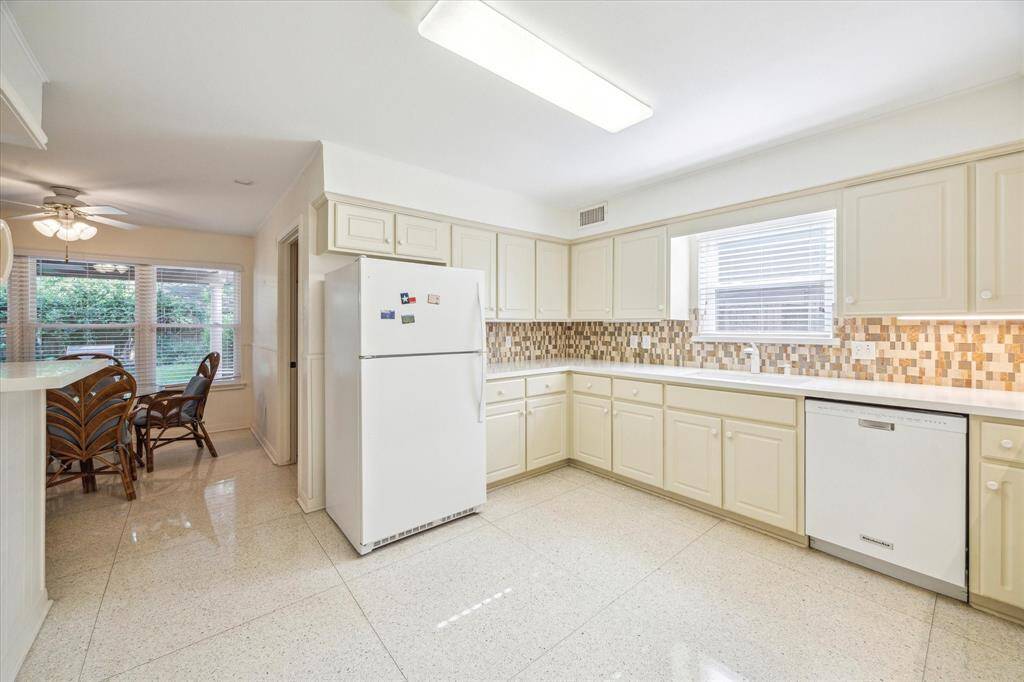 This alternate view of the kitchen showcases the convenient bar area and its open connection to the spacious breakfast room. The layout is perfect for casual dining and effortless entertaining, with a natural flow that brings everyone together.