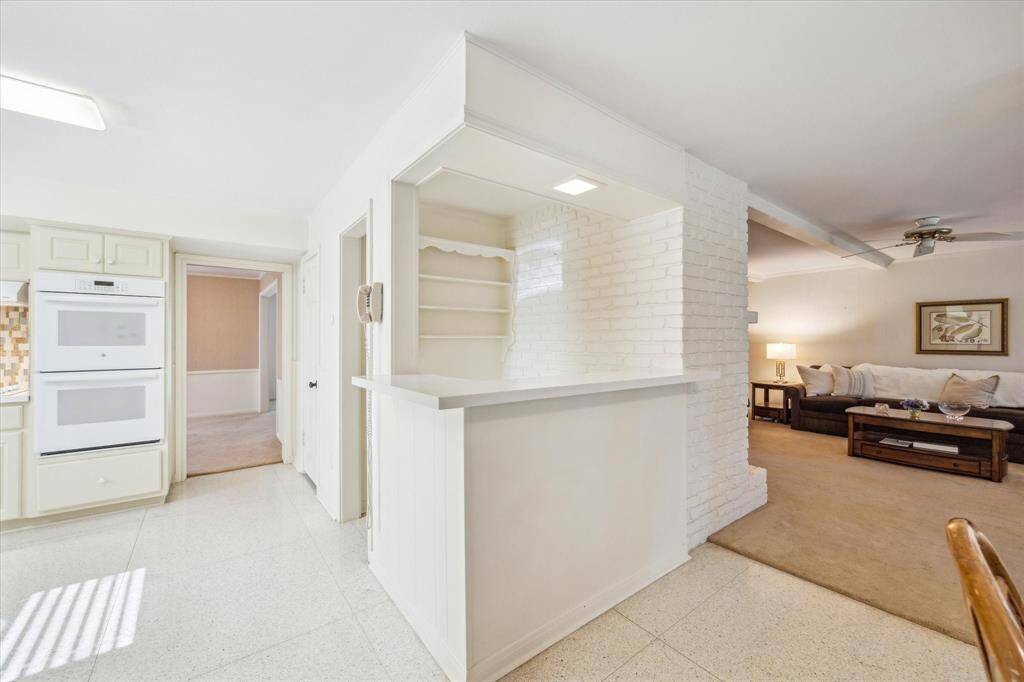 The breakfast room offers a bright and cheerful space with lovely views overlooking the backyard, creating a perfect spot to start the day. The utility room is conveniently located off the breakfast room and includes built-in storage along with space for an additional refrigerator or freezer.
