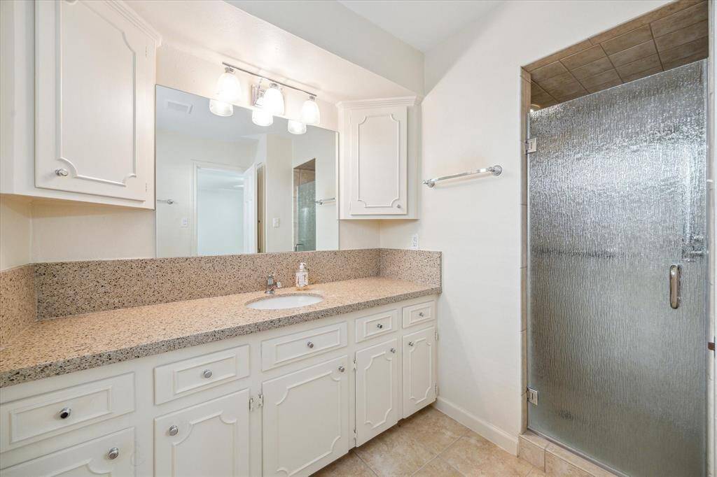 This versatile downstairs room can serve as a bedroom or study, featuring a full closet and flexible layout. Conveniently accessible from both the main entry and the bedroom hallway, it offers privacy and functionality for guests, work, or quiet retreat.