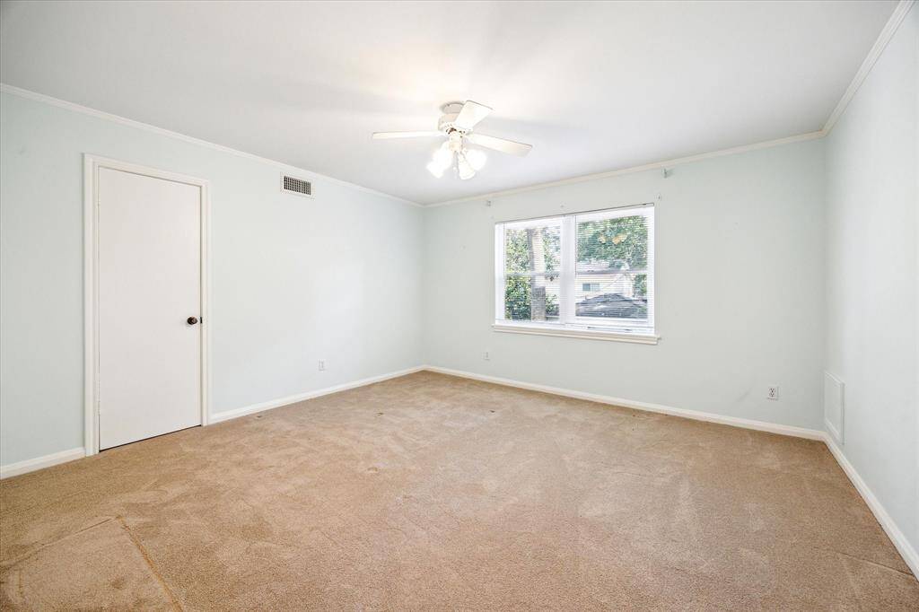 This secondary bedroom offers comfort and space, featuring a walk-in closet for ample storage.