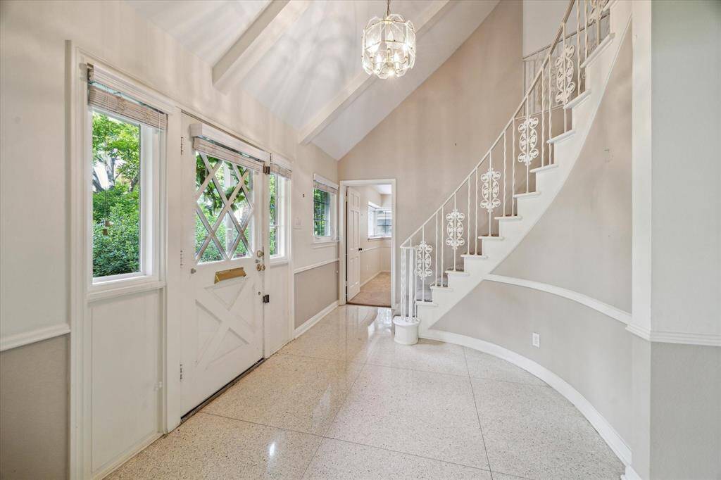 Walking into the large foyer, you are greeted by soaring ceilings that create a sense of grandeur. This impressive space provides access to the study, formal dining room, and living room, offering a welcoming and elegant introduction to the home.
