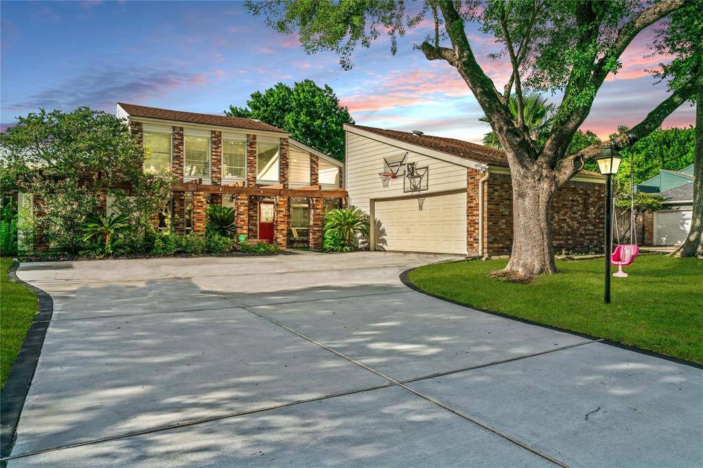 This charming two-story brick home features a spacious driveway, attached garage, and mature trees. The well-maintained front yard adds to its curb appeal, making it an inviting option for prospective buyers.