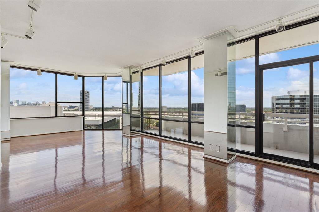 Spacious living room with floor to ceiling windows.