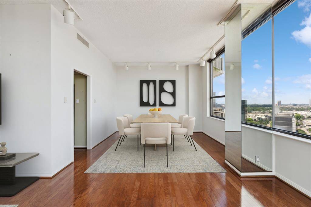 Formal dining room open to the living room with access to the kitchen. Image shown virtually staged.