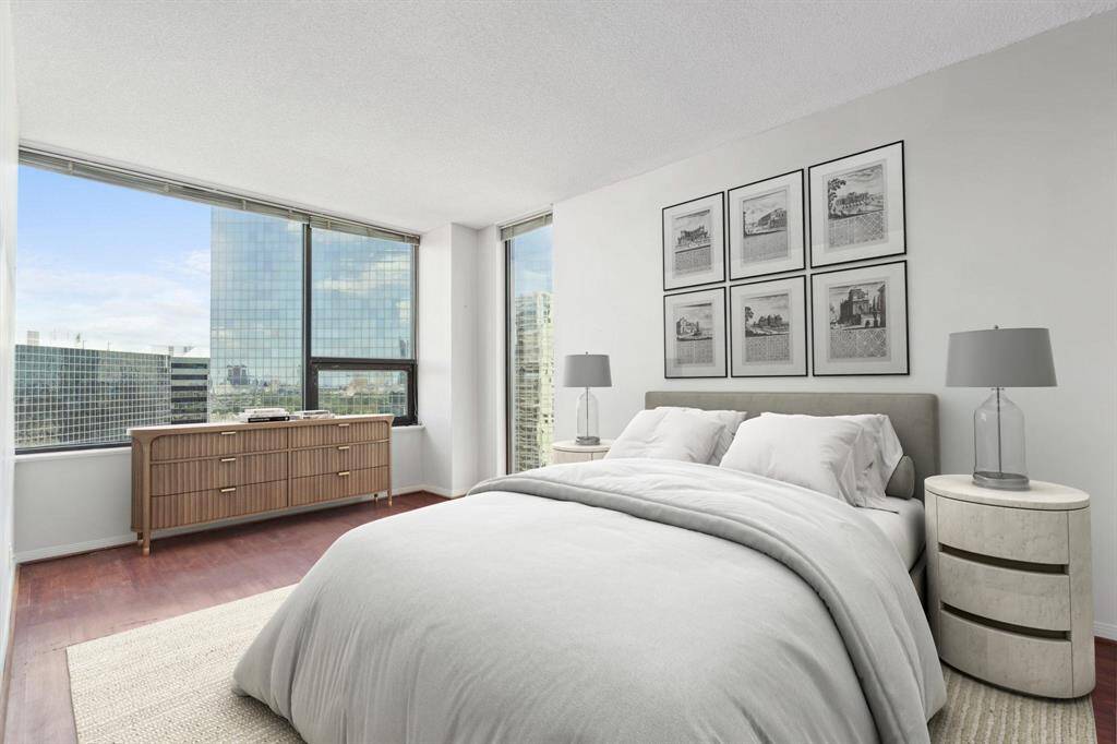 Primary bedroom with a walk-in closet and private bathroom. Image shown virtually staged.