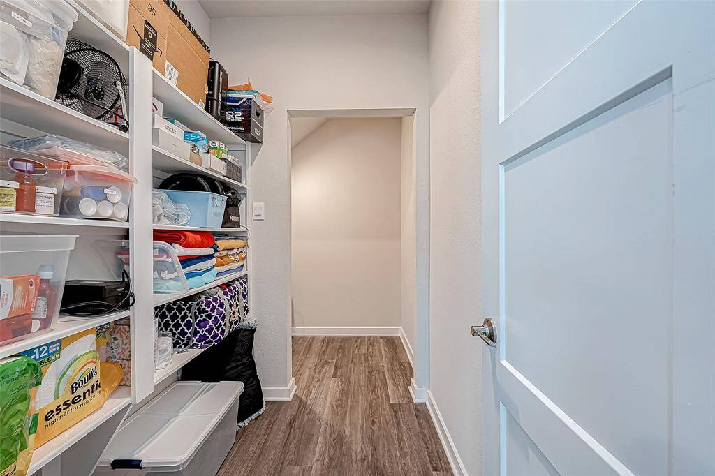 Large storage area under the staircase just off the front bedroom/ home office.