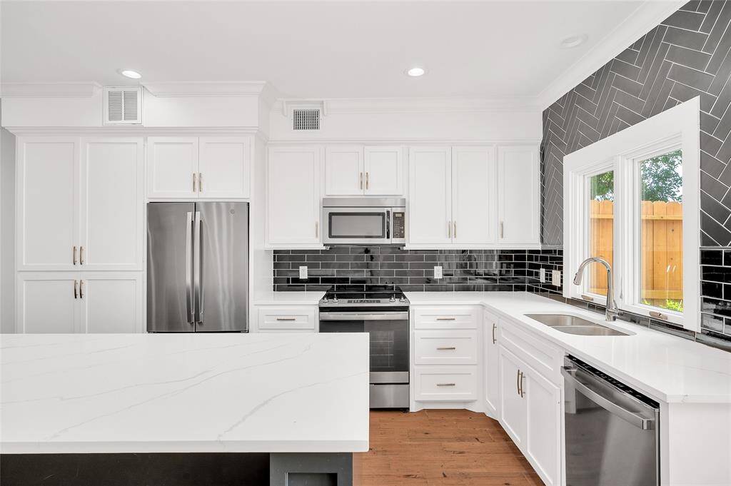 Totally renovated kitchen with newer quartz countertops, appliances, large island, wine refrigerator and so much more.