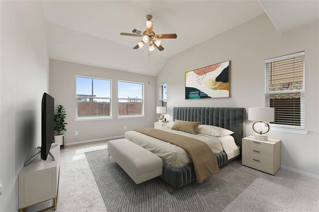 The spacious primary suite is a peaceful retreat located on the first floor.