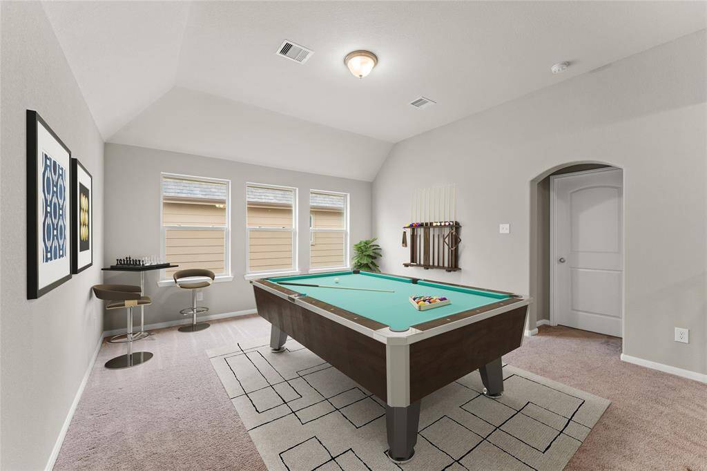 Upstairs you'll find a large game room filled with light from wide windows. It's the perfect spot for a home theater, play area, or home office.