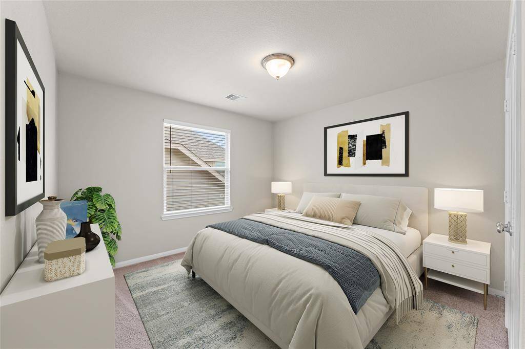 This cozy second bedroom features soft carpet flooring, a large window, and a generous closet. It’s a perfect space for a guest room, nursery, or a peaceful retreat for a family member.