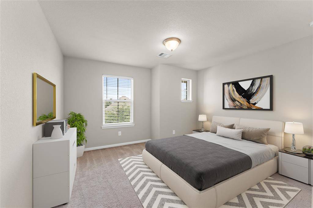 Bright and inviting, this third bedroom offers ample space and natural light through its wide window.