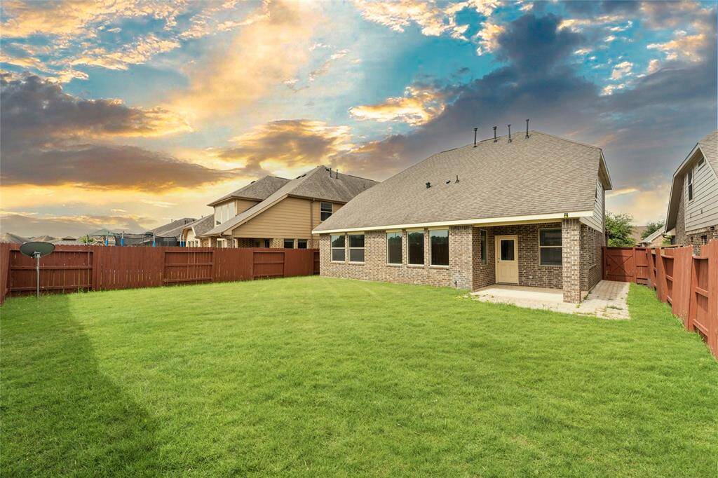 Step outside to a lush, green backyard with plenty of space for fun and relaxation.