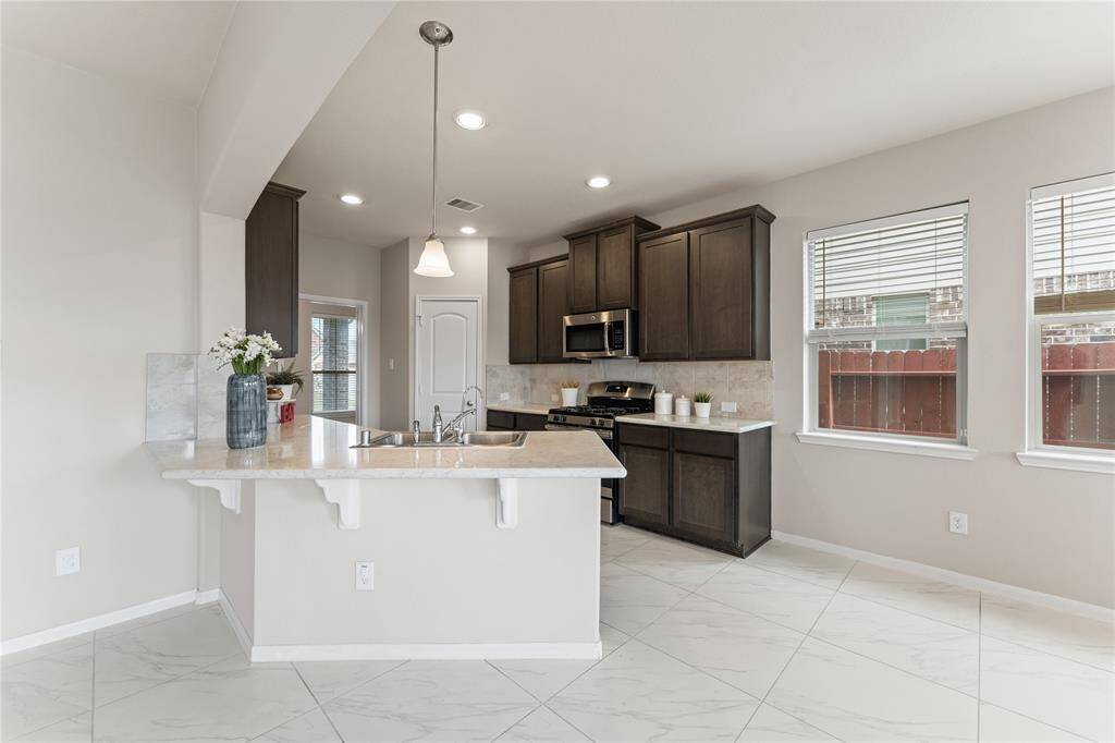 Whether you're preparing a quick breakfast or hosting a dinner party, this kitchen offers both style and function.