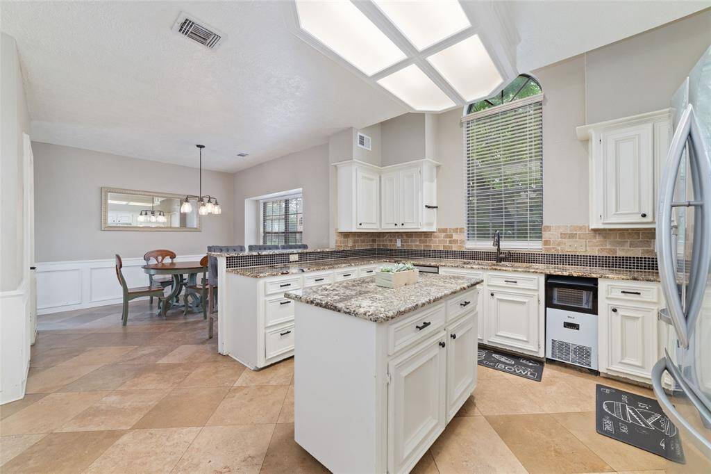 Island in kitchen and travertine flooring
