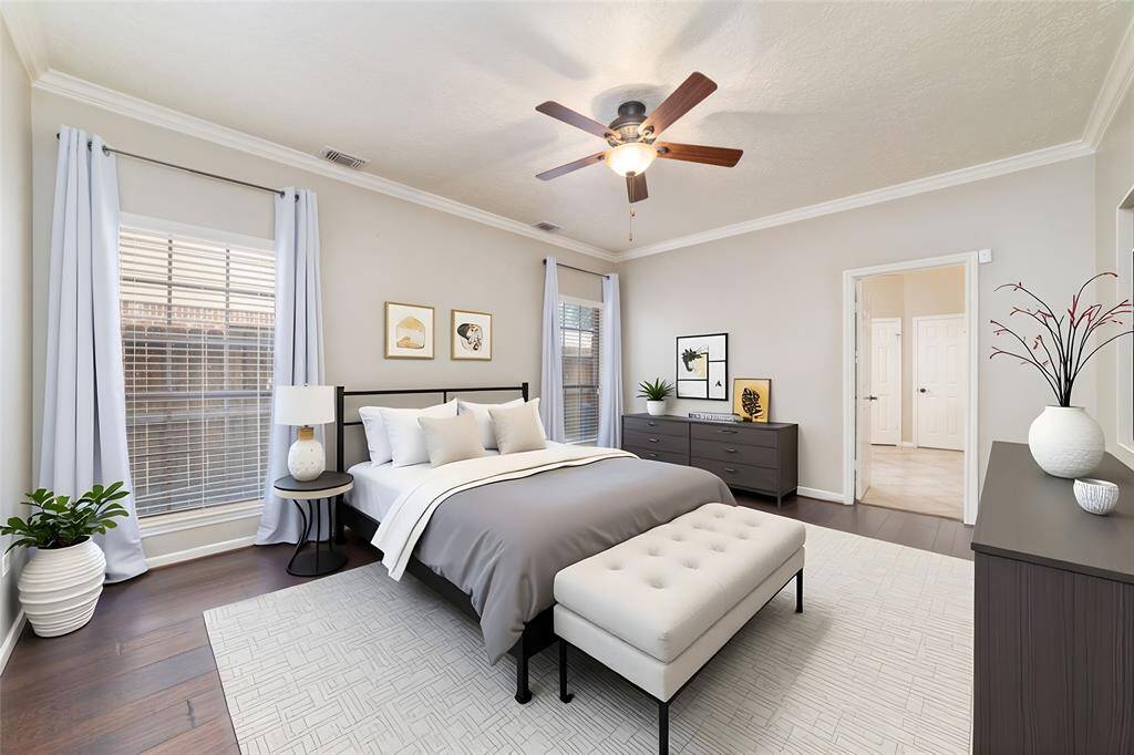 Spacious primary bedroom located down stairsvirtually staged