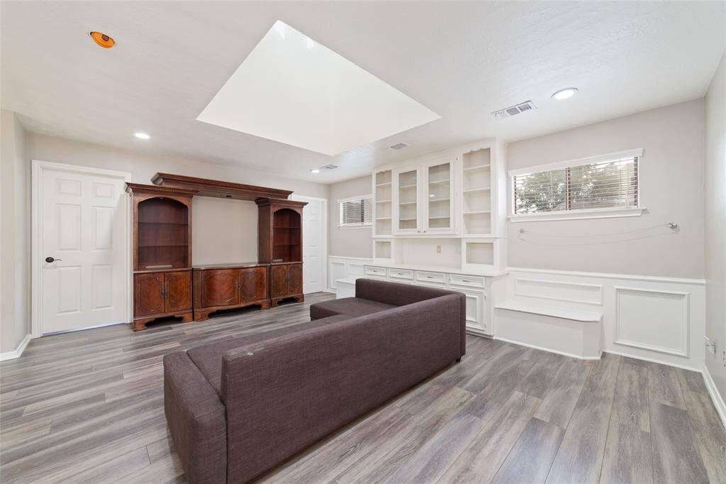 Gameroom upstairs with vinyl flooring and natural light