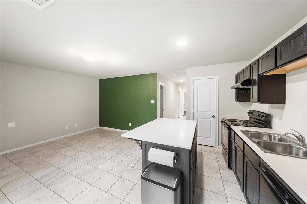 Island conveys with home for additional storage and prep space.