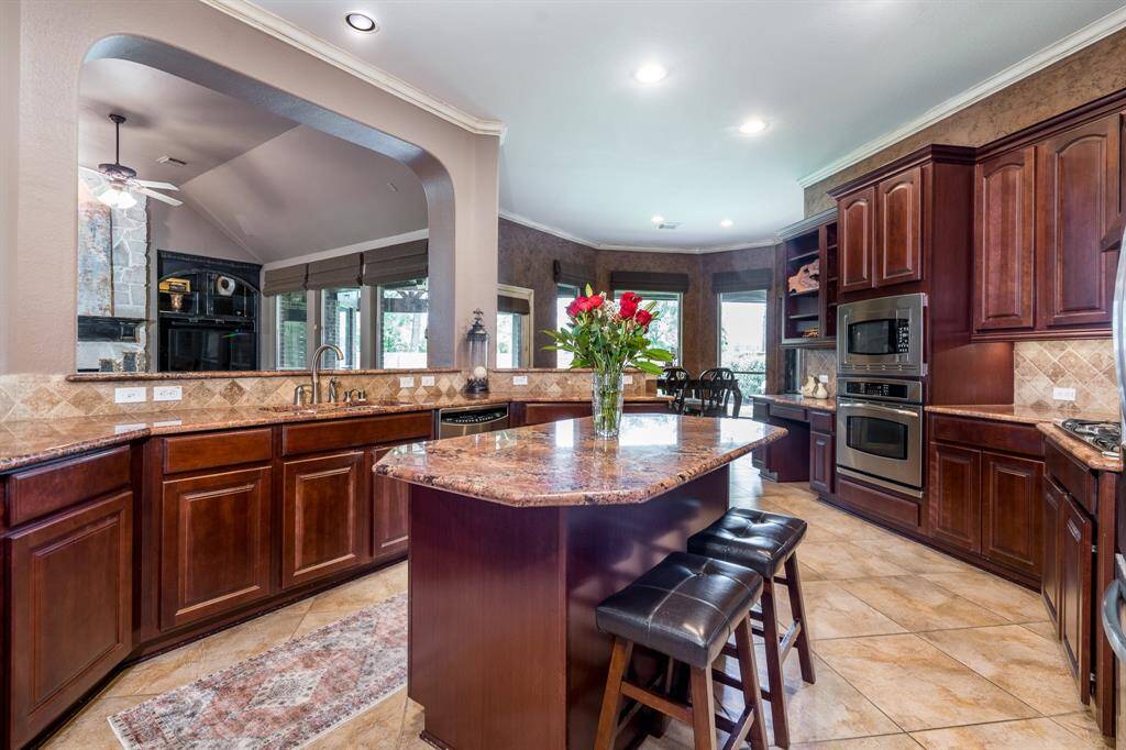 Another view of all the counter and cabinet space available.  The breakfast nook has a bay window looking out to the tranquil oversized backyard.