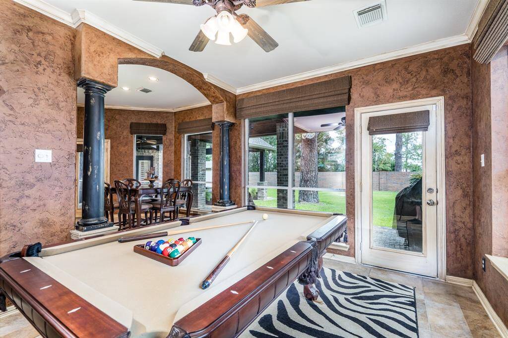 The game room off the kitchen has a door to the backyard so everyone can enjoy both the indoors and outdoors.