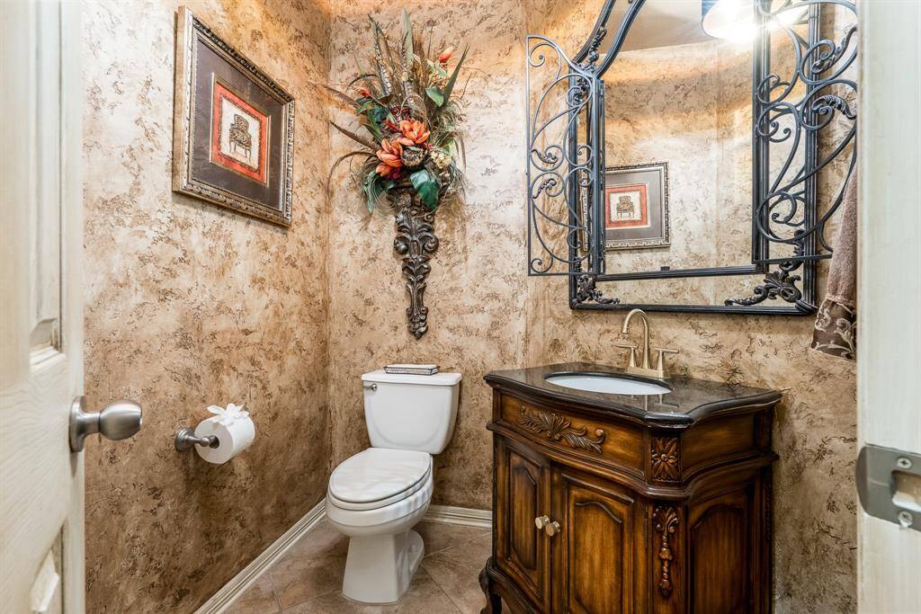 The powder bath is stunning with it's wrought iron mirror and beautiful vanity.