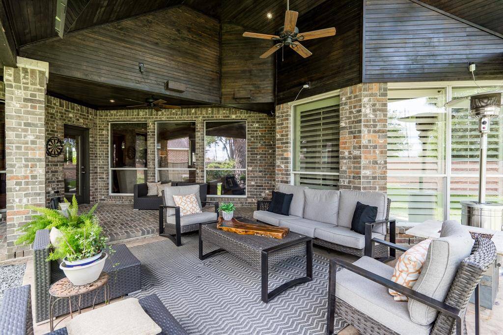 Fantastic covered custom patio, with lights, fans, and a mounted TV. You can enjoy this space year round.